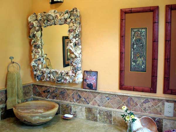 Custom stone sinks, shell mirrors, marble surrounds